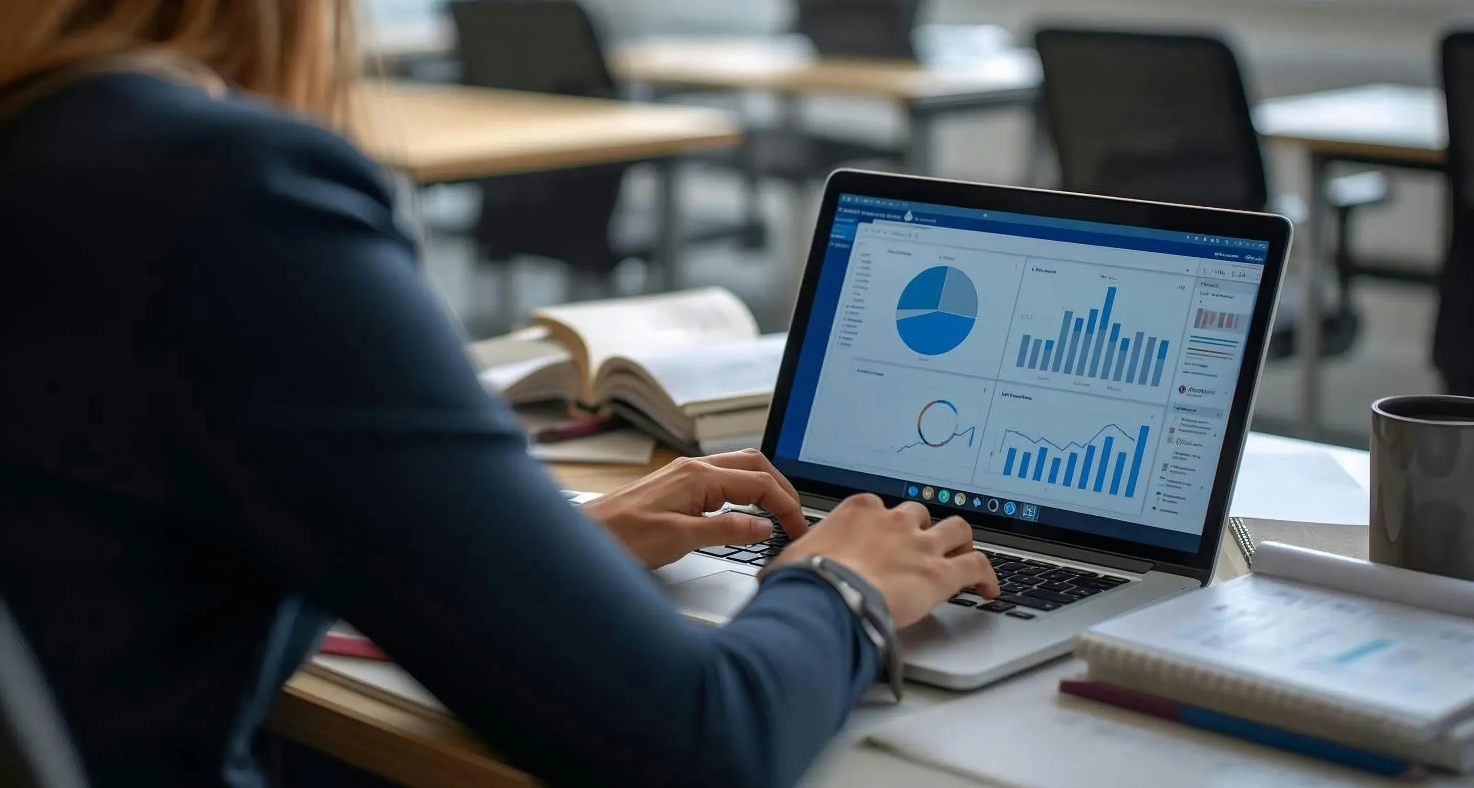 An employee analyzes charts in Excel on a laptop